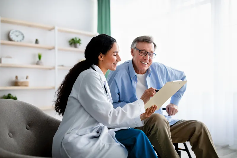 Doctor reviewing paperwork with a patient in a clinic