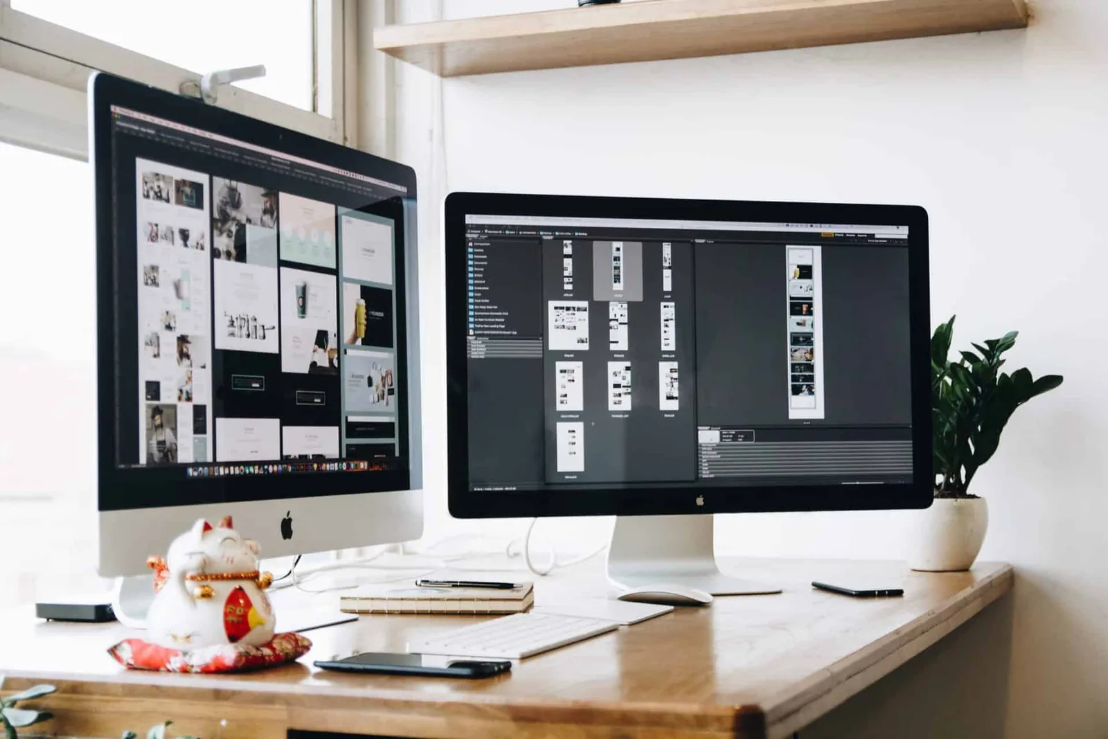 2 computer screens side by side on a desk showing graphic design work