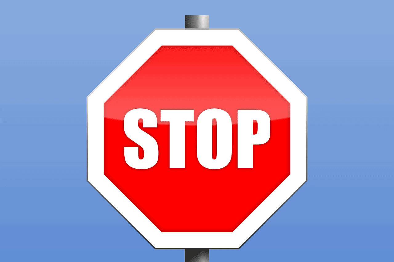 A red octagonal stop sign on a blue background.